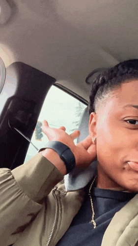 a woman wearing a watch is sitting in a car