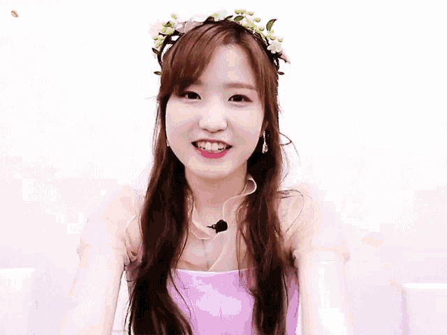 a girl wearing a flower crown and a purple dress