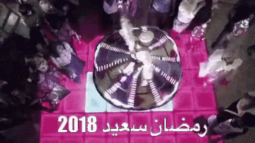 a group of people are gathered around a ferris wheel with the year 2018 written on it