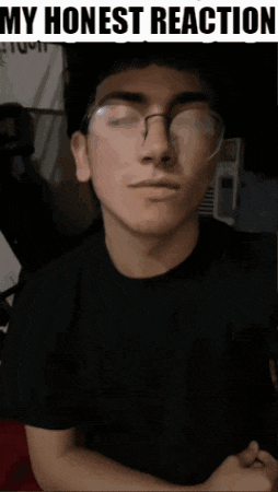 a man wearing glasses and a black shirt with the words " my honest reaction " on the top