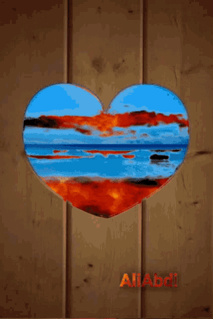 a heart shaped painting of a sunset over the ocean with the name allabdl below it