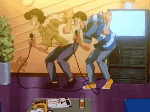 a couple of men singing into microphones in front of a tv
