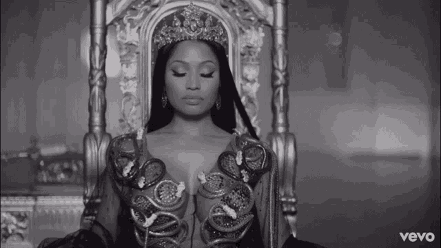 a black and white photo of a woman wearing a crown and a vevo logo behind her