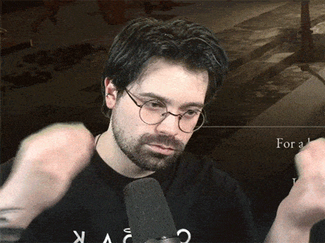 a man wearing glasses and a black shirt that says for a on it