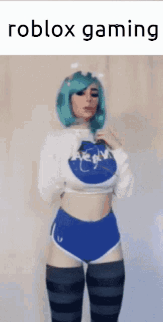 a woman with blue hair is wearing a nasa shirt and shorts