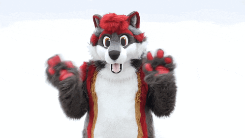 a furry wolf mascot is standing in the snow