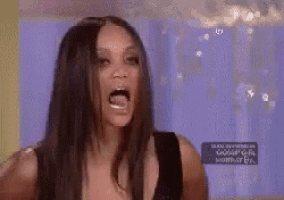 a woman with long black hair is making a funny face .