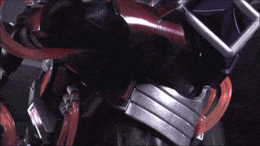 a close up of a robot 's arm with a red hose attached to it