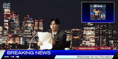 a man is reading a newspaper in front of a breaking news sign