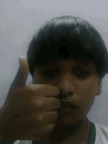 a close up of a person 's face with their finger on their nose