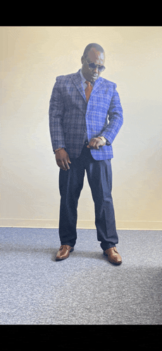 a man in a suit and tie is standing on a carpet