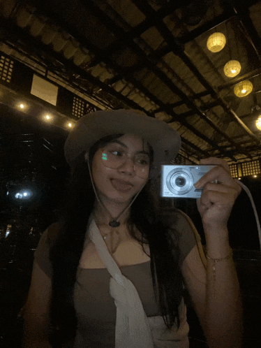 a woman taking a picture of herself with a camera
