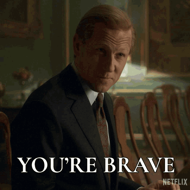a man in a suit and tie with the words you 're brave on the bottom