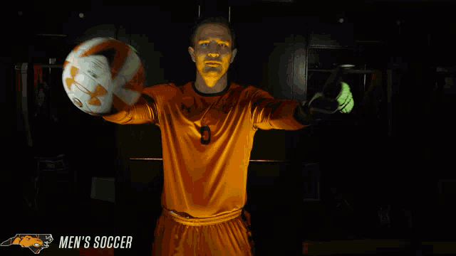 a man holding a soccer ball with the words men 's soccer in the corner