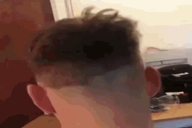 a close up of a man 's head with a shaved head
