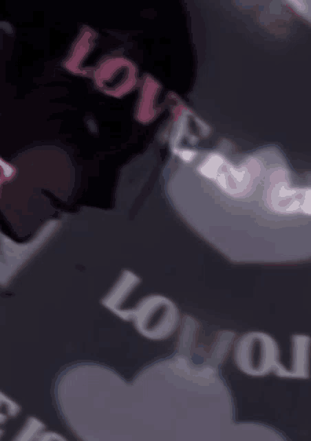 a blurry picture of a person with the word love written on it