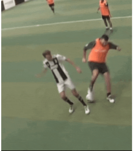 a blurry picture of two soccer players on a field .
