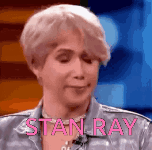 a close up of a woman 's face with the name stan ray in pink letters