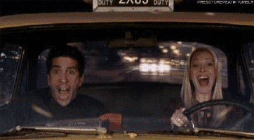 a man and a woman are laughing in a taxi with a duty sign on the top
