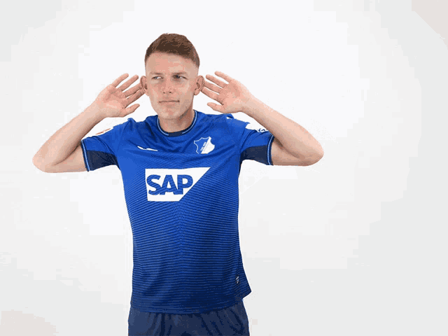 a man wearing a blue shirt with sap on it
