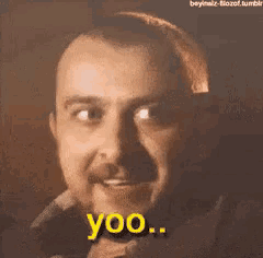 a man with a beard is making a funny face and saying yoo .