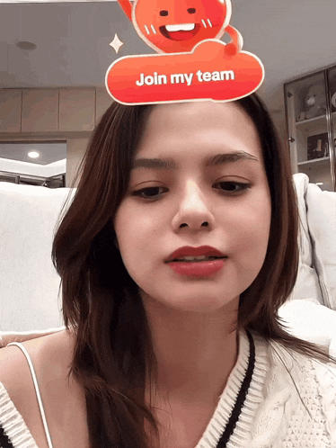 a woman with a red sticker on her head that says join my team