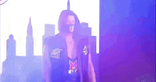 a man wearing a mask is standing in front of a city skyline in a purple and blue background .