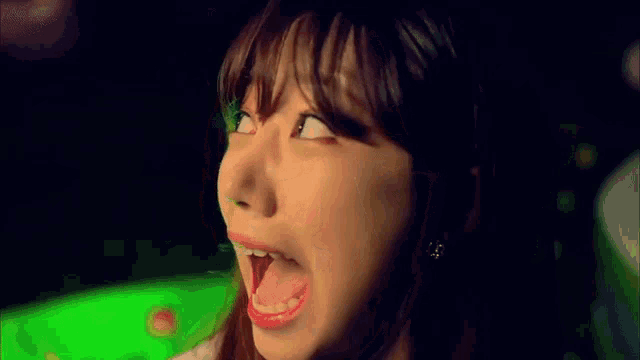 a woman is sticking her tongue out and making a funny face .