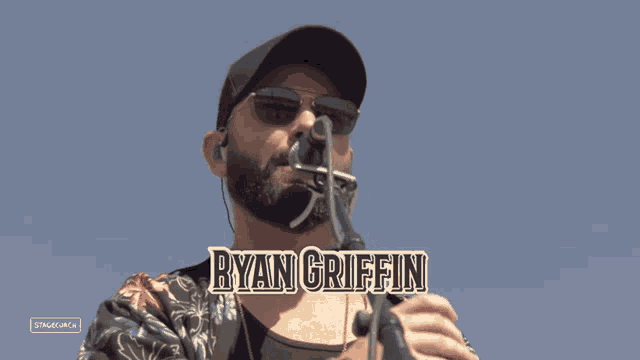 ryan griffin is playing a harmonica on stage