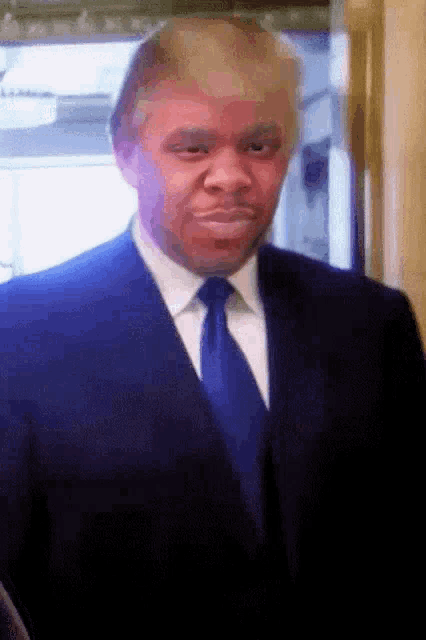 a man in a suit and tie with a fake donald trump face
