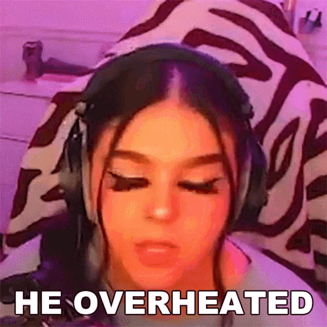a girl wearing headphones says he overheated in front of a zebra print blanket .