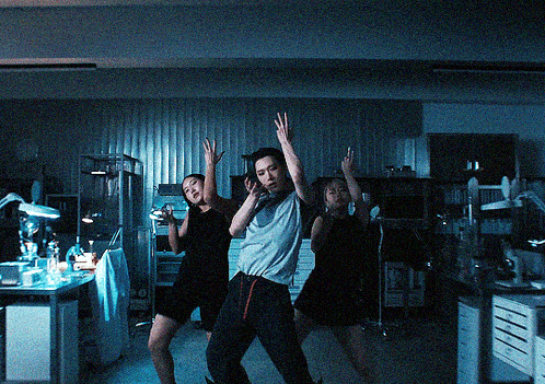 a group of people dancing in a dark room