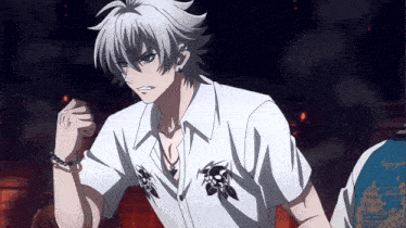 a man in a white shirt with skulls on the sleeves