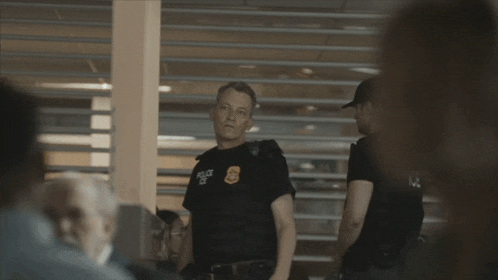 a police officer wearing a black shirt that says police on it