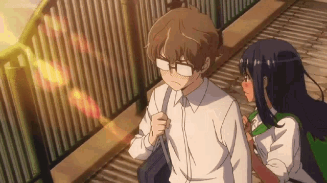 a boy and a girl are standing next to each other .