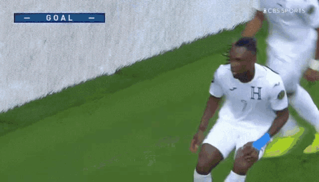 a soccer player with the letter h on his jersey is celebrating a goal