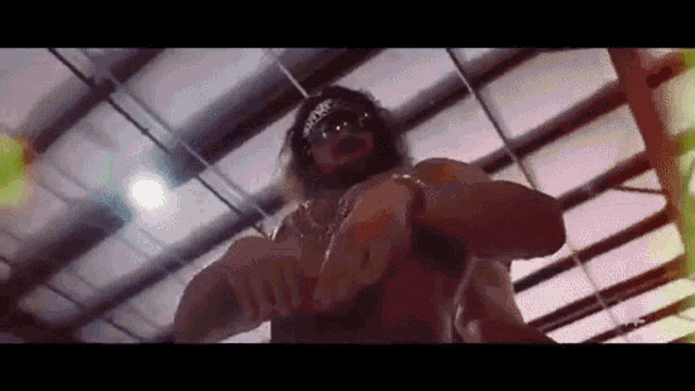 a man with a beard and sunglasses is standing in a wrestling ring .