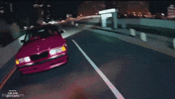 a pink car is driving down a highway with a watermark that says just go image.com