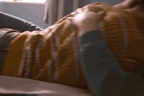 a person laying on a bed in front of a double poster