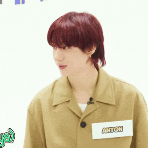 a young man with red hair has a name tag that says anton on it