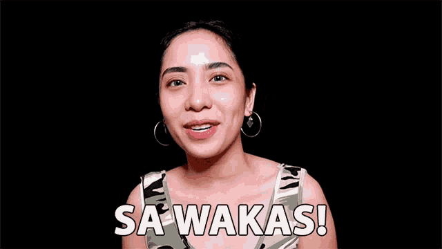 a woman wearing hoop earrings says sa wakas on a black background