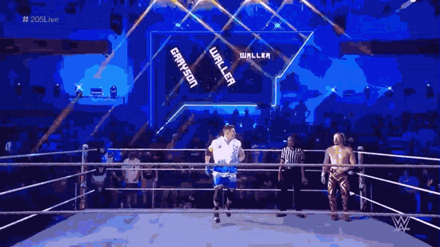 a man in a white shirt stands in the middle of a wrestling ring with the words waller on the wall