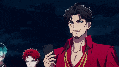 a man in a red shirt is holding a cellphone