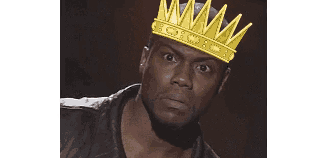 a man is wearing a crown on his head and looking at the camera .