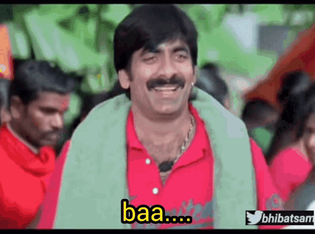 a man with a mustache is smiling with the word baa on his face