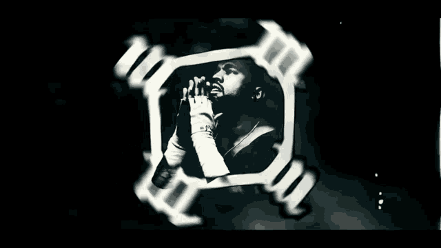 a black and white photo of a man with a microphone