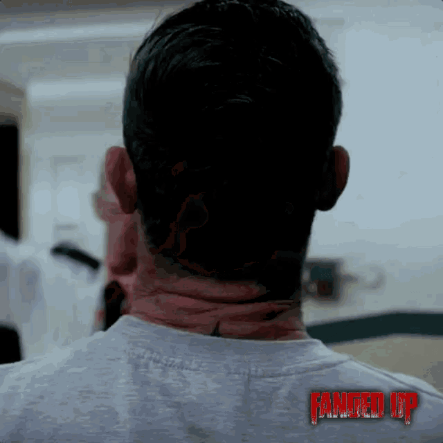 the back of a man 's neck is shown in a fanged up poster