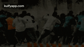 a group of people are jumping in the air while dancing in a crowd .