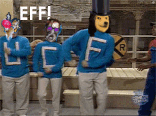 a group of people wearing blue sweaters with the letter l on them