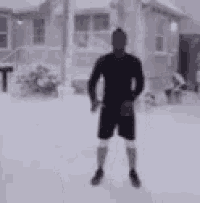 a man is standing in the snow with a bird on his feet